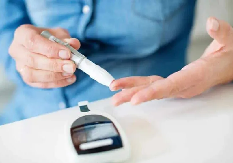 a woman pricking her finger for blood glucose test