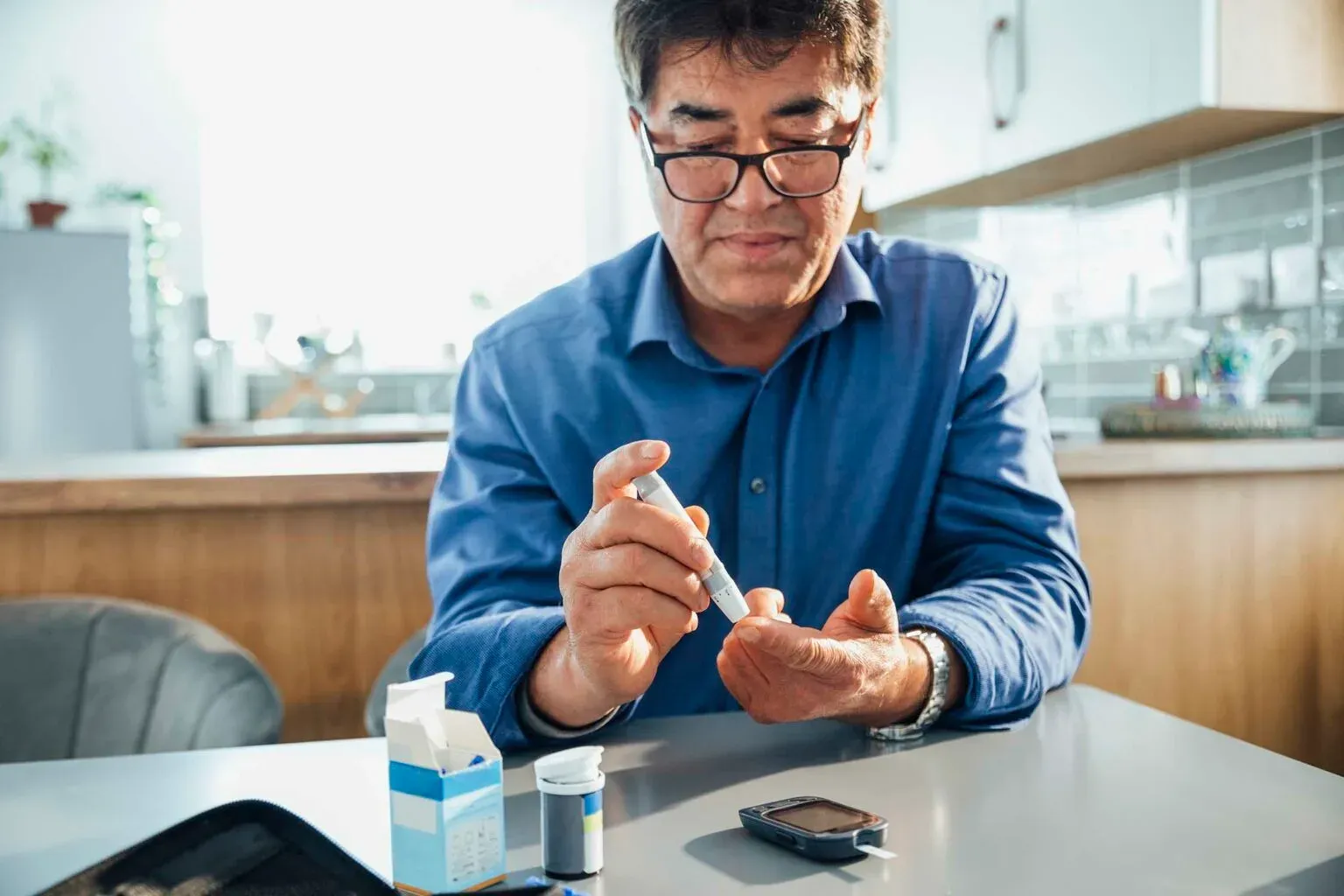 a male patient with Type 2 diabetes monitoring his blood glucose using a blood glucose meter